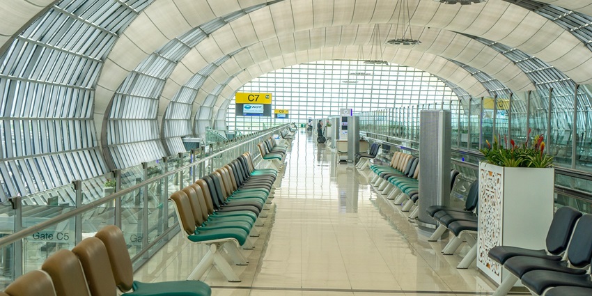 Inside Mansa airport terminal, one of the airports in Zambia, with a round white and blue glass ceiling and empty chairs lined up