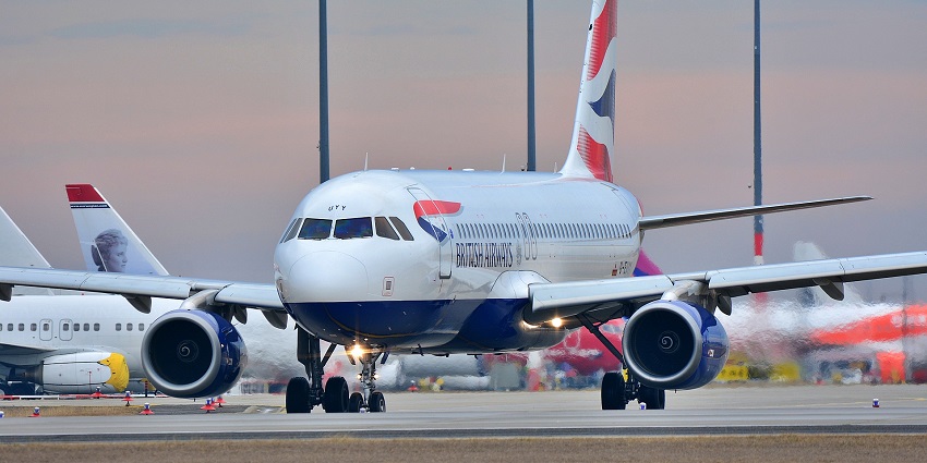 British Airways aeroplane parked near the runaway with multiple aeroplanes behind it