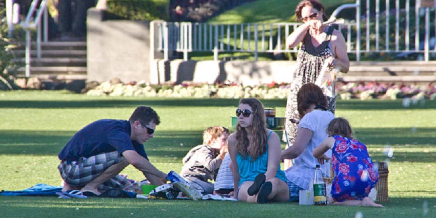 A grassy picnic in the Marine Parade scenic park with, vibrant garden background.