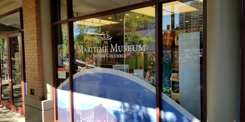 An image of the Maritime Museum of British Columbia entrance showcasing glass panels, brick exterior, and signage.