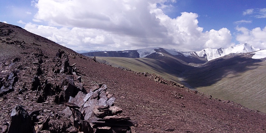 An image of a remote valley in Ladakh with a winding trail, ideal for trekking in July.