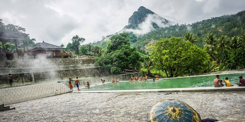 Natural hot springs surrounded by lush greenery, offering a relaxing geothermal soak.