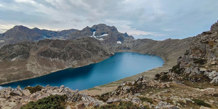 Marsar lake with a small, deep blue water body surrounded by rocky shores and hills