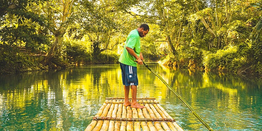 An image of a person rafting on the Martha Brae River, one of the things to do in Jamaica.