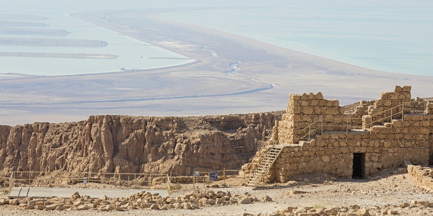 Masada is an ancient castle fort on a plateau, a symbol of Jewish resistance and strength.
