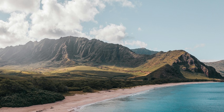 A breathtaking aerial view of a tropical beach in Maui, Hawaii, with crystal-clear waters.