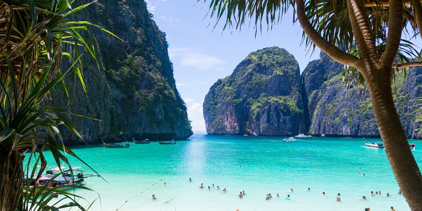The stunning Maya Bay, with its white sands, emerald waters, and towering limestone cliffs