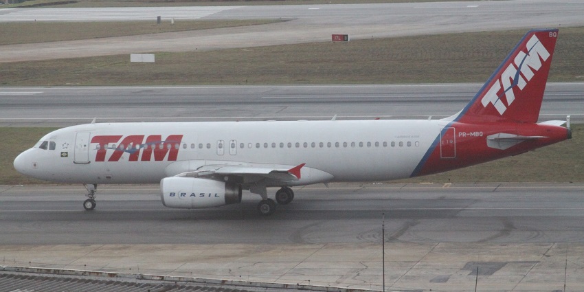 MBQ Airbus A320 red and white commercial aeroplane parked on the runway with signages
