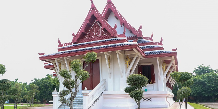 A peaceful view of a monastery surrounded by lush greenery and serene surroundings