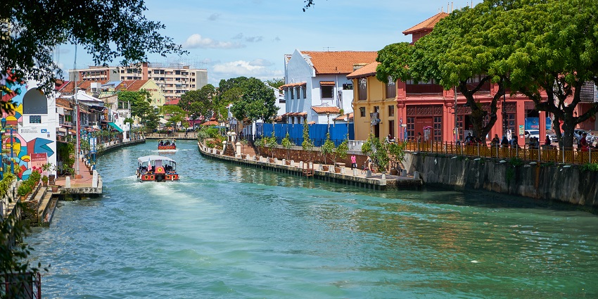 An image of people cruising on the Melaka River, one of the tourist attractions in Malacca, Malaysia