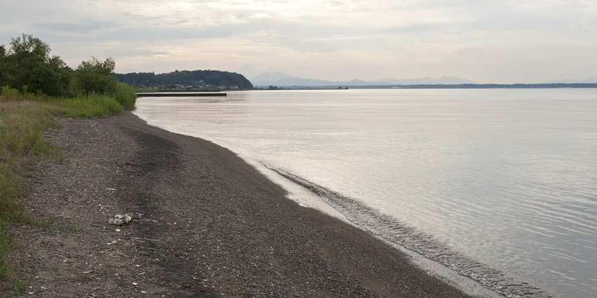 The majestic shore of the Miho Beach, one of the black sand beaches in the world