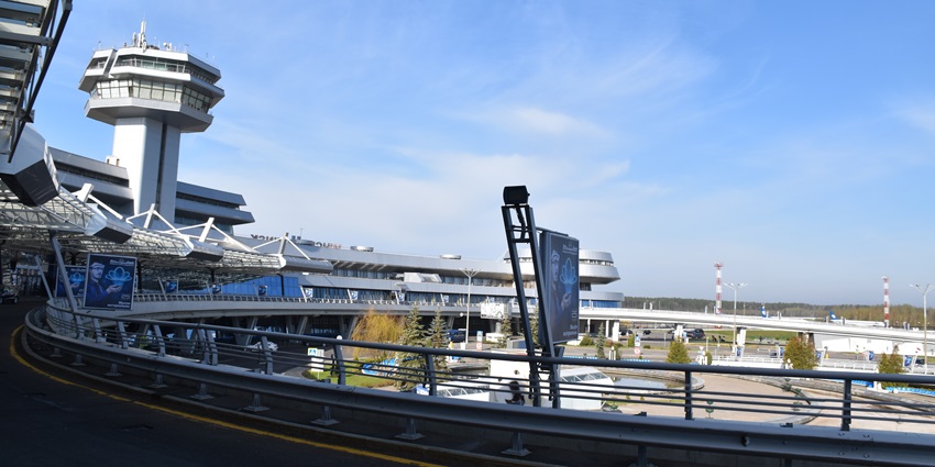 Terminal of Minsk National Airport with modern white architecture connected to the roads.