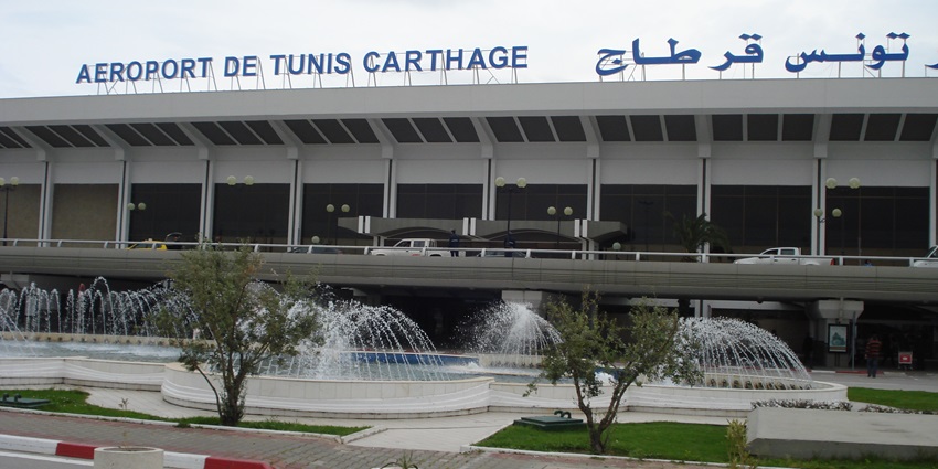 Monastir Habib Bourguiba International Airport, one of the airports in Tunisia with its name visible, greenery, trees and parked cars in front