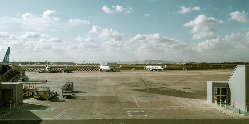A terminal with three airplanes parked on a runway at one of the airports in Djibouti.