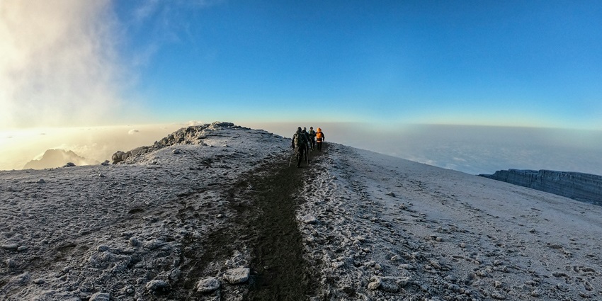 Rainforest paths, rocky slopes, and the iconic snow-capped summit of Mount Kilimanjaro.