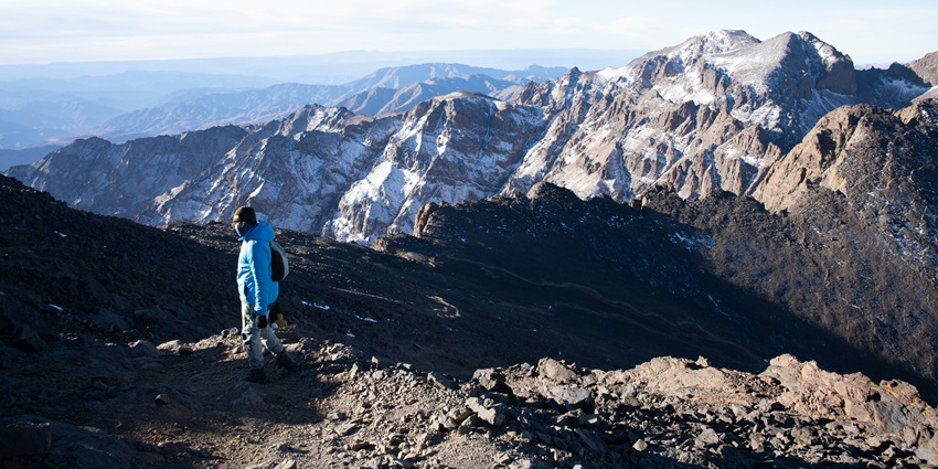 High Atlas mountain peaks rising through drifting clouds near the summit of Mount Toubkal.