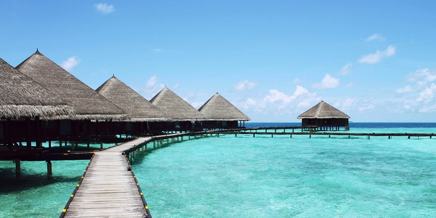 Image of small cottages lined up on water in Munda, one of the tourist places in Solomon islands