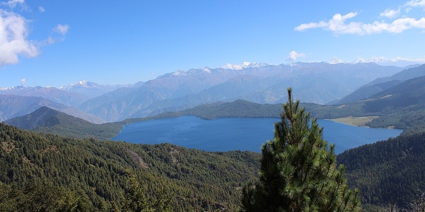Rara Lake in Nepal from Murma Top with a small water body surrounded by green shores.