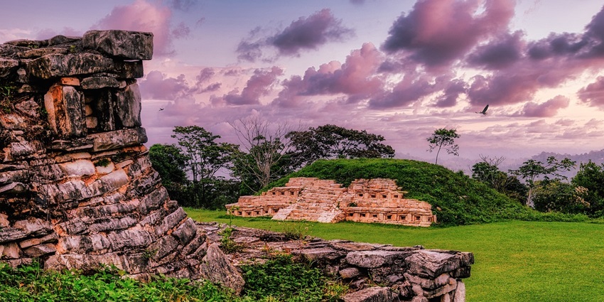 Ancient Mayan ruins resting under a blue sky, one of the places to visit in Copan ruins.