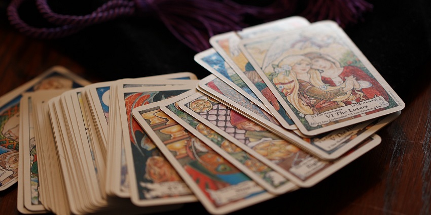 An image showing tarot cards and mystical artefacts, similar to the Museum of Tarot.