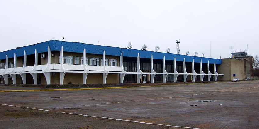 Mykolaiv International Airport with a car approaching from the right under a clear sky