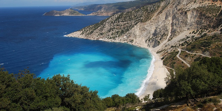 Myrtos Beach is among the top bikini beaches in the world featuring stunning white pebble with deep blue waters and towering cliffs.
