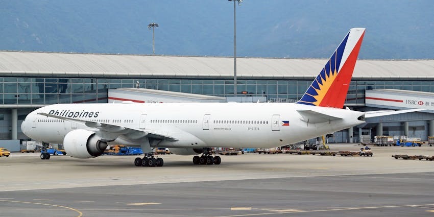 White aeroplane parked on the runway of one of the airports in Saudi Arabia with a unique design on the tail