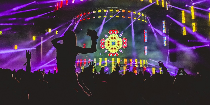 An image of NH7 Weekender with a lively crowd, indie bands performing, and vibrant stage lighting.