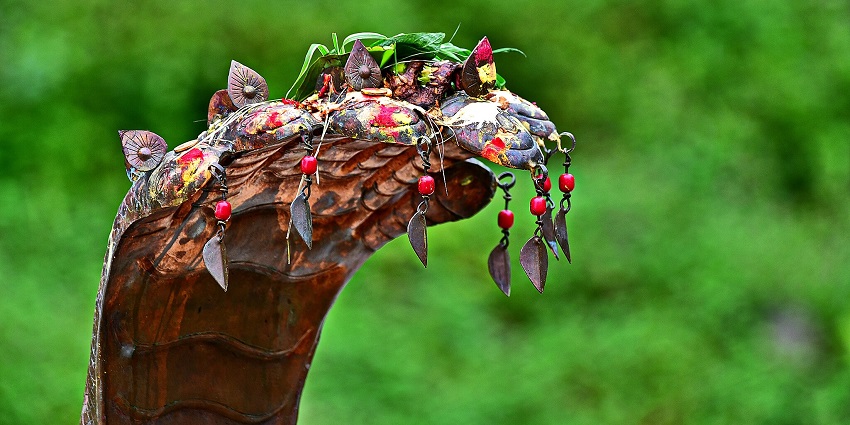 An image of Nag Panchami festival, with a copper statue of Naag (snake) in the stone cave, for festivals in Shravan month.