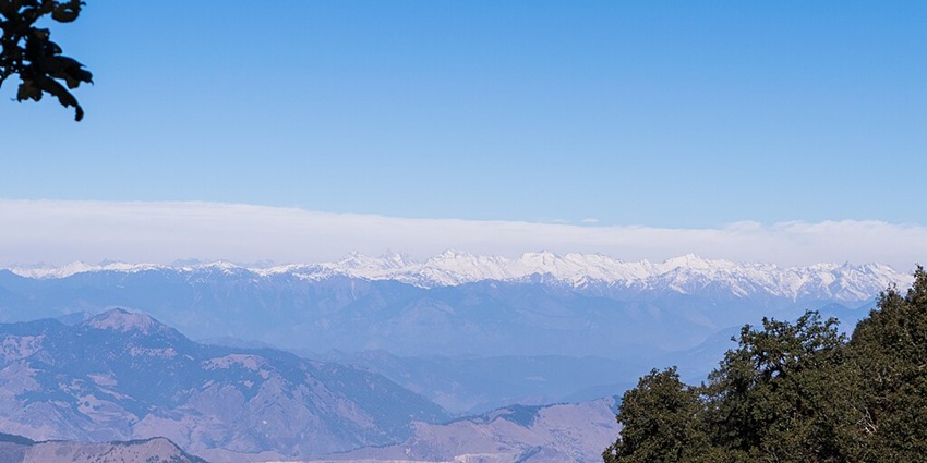An Image showing the view of Bandarpunch range and Swargarohini from the Nag Tibba summit, one of the best Indian treks.