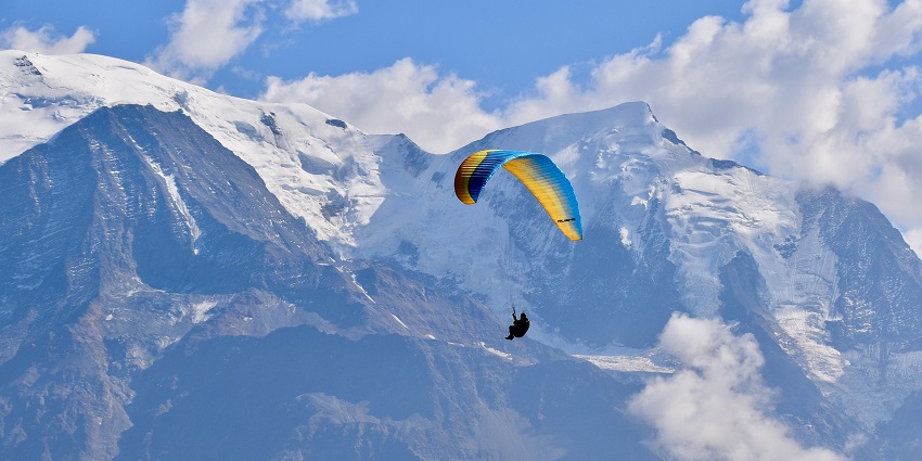 A paraglider soaring in Nainital, which is one of the spots for paragliding in India.