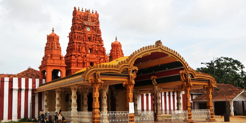The entrance of Nallur Kandaswamy Temple with its golden gopuram and intricate carvings.