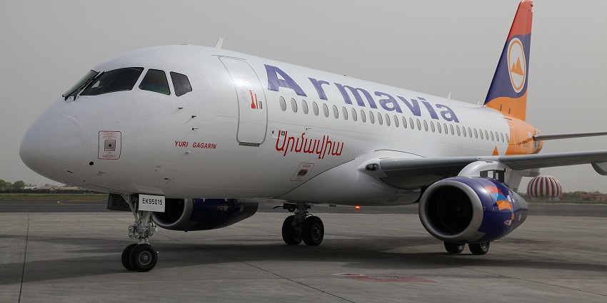 Aircraft with signage parked on the runway of Namibe Airport, one of the airports in Angola.