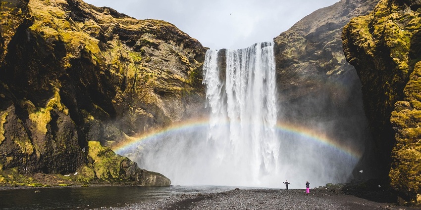 A waterfall where a rainbow is created, similar to the Naneghat Reverse Waterfall.