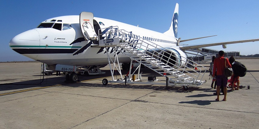 Passengers standing at the open gate of an aeroplane at one of the airports in Iraq.