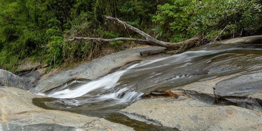 Glide down smooth rock formations into refreshing waters for a thrilling adventure