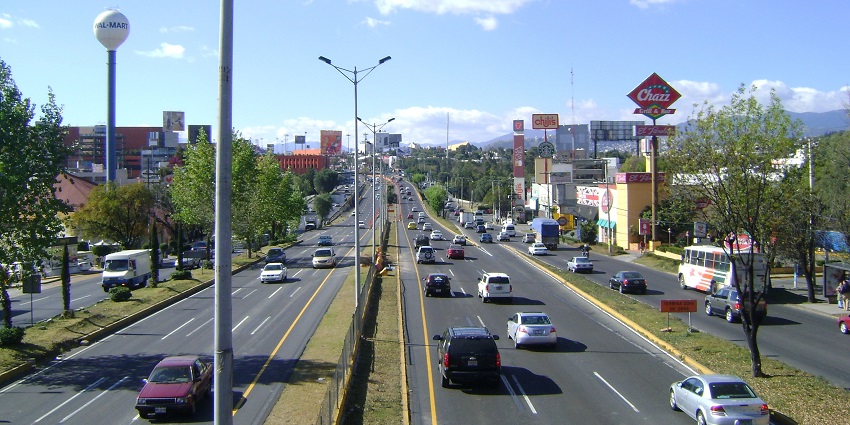 Buildings dot across the landscape in an old and historic city with hills stretching far away