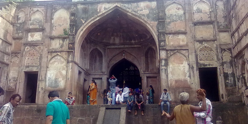 Distant view of the Neelkanth Mahadev temple amidst rugged mountains