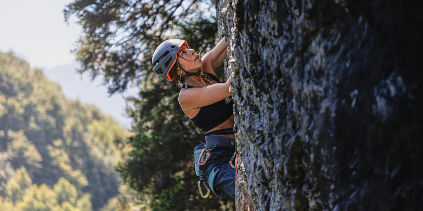 View of a woman rock climbing the challenging cliffs of this wildlife sanctuary