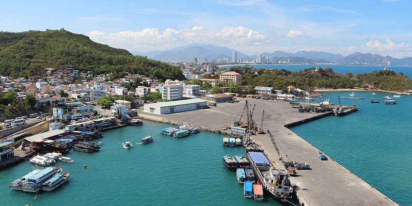 An image showing Nha Trang port, Vietnam, with boats docked along the waterfront area.