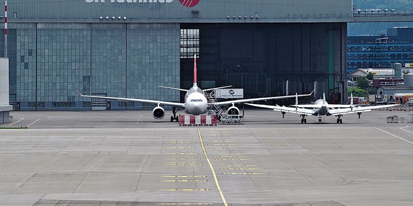 Top view of Nnamdi Azikiwe International Airport with multiple planes and cars parked around