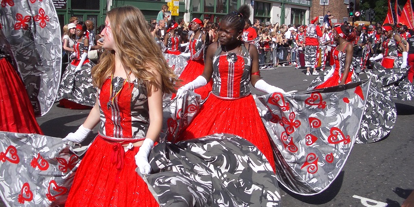 A vibrant performer in colorful attire showcasing the festive spirit of the carniva