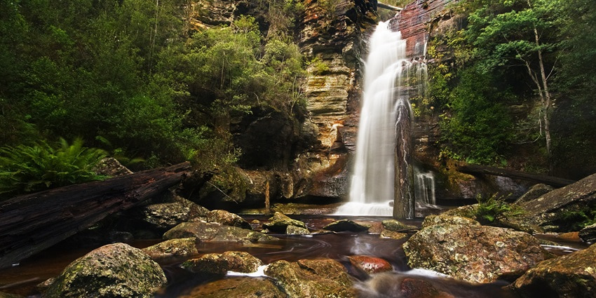 An image of the majestic Nuʻuuli Waterfall, one of the places to visit in American Samoa.