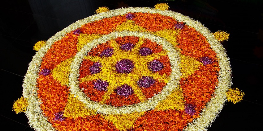 An image of stunning rangoli made with flowers and colours to celebrate the cultural crop festival.
