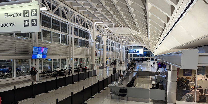 Interior of the Ontario International terminal with modern architecture and people.