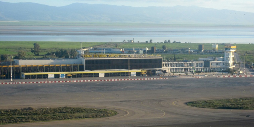 Oran Es Senia Airport with control tower, runways, and green fields in the background