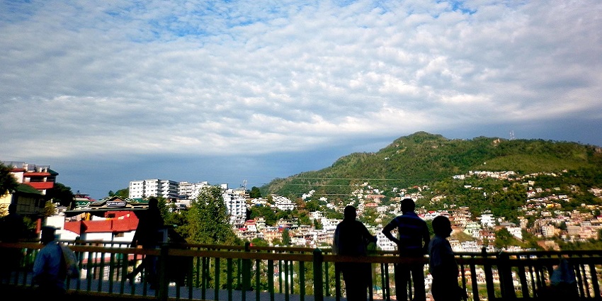 People viewing Solan city from the Solan bypass with multiple buildings on the mountains