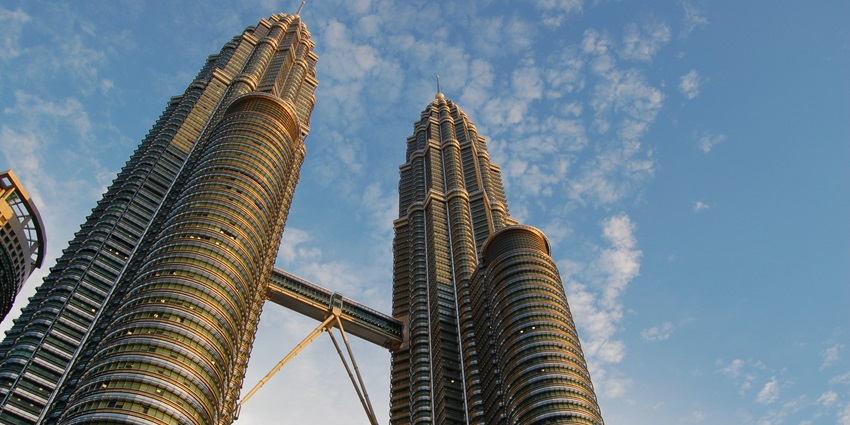 A breathtaking low-angle view of the iconic Petronas Towers in Kuala Lumpur, Malaysia.