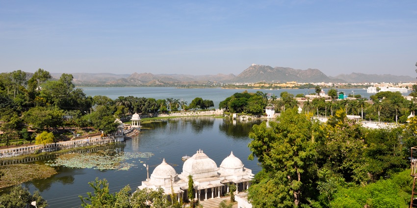 View of the biggest lake in Udaipur, surrounded by lush greenery