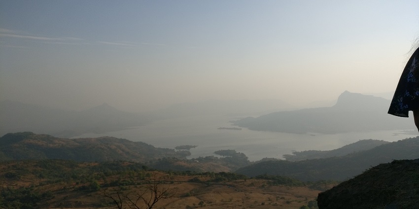 Pawna lake from top with a large water body, distant greenery and distant hills